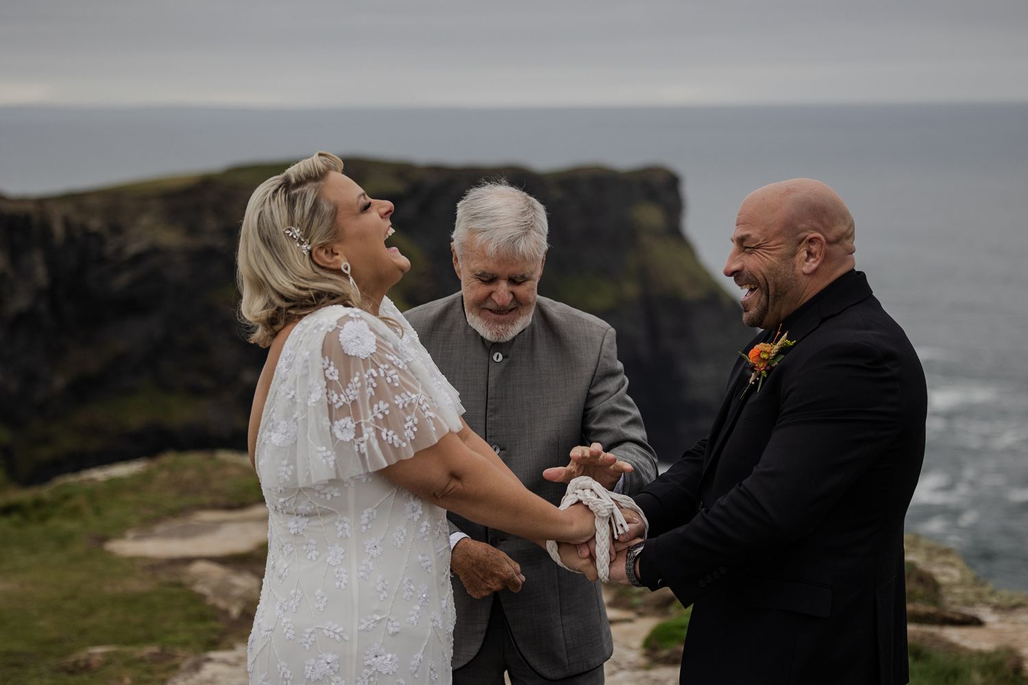 Handfasting ceremony at the Cliffs of Moher during intimate Ireland elopement.