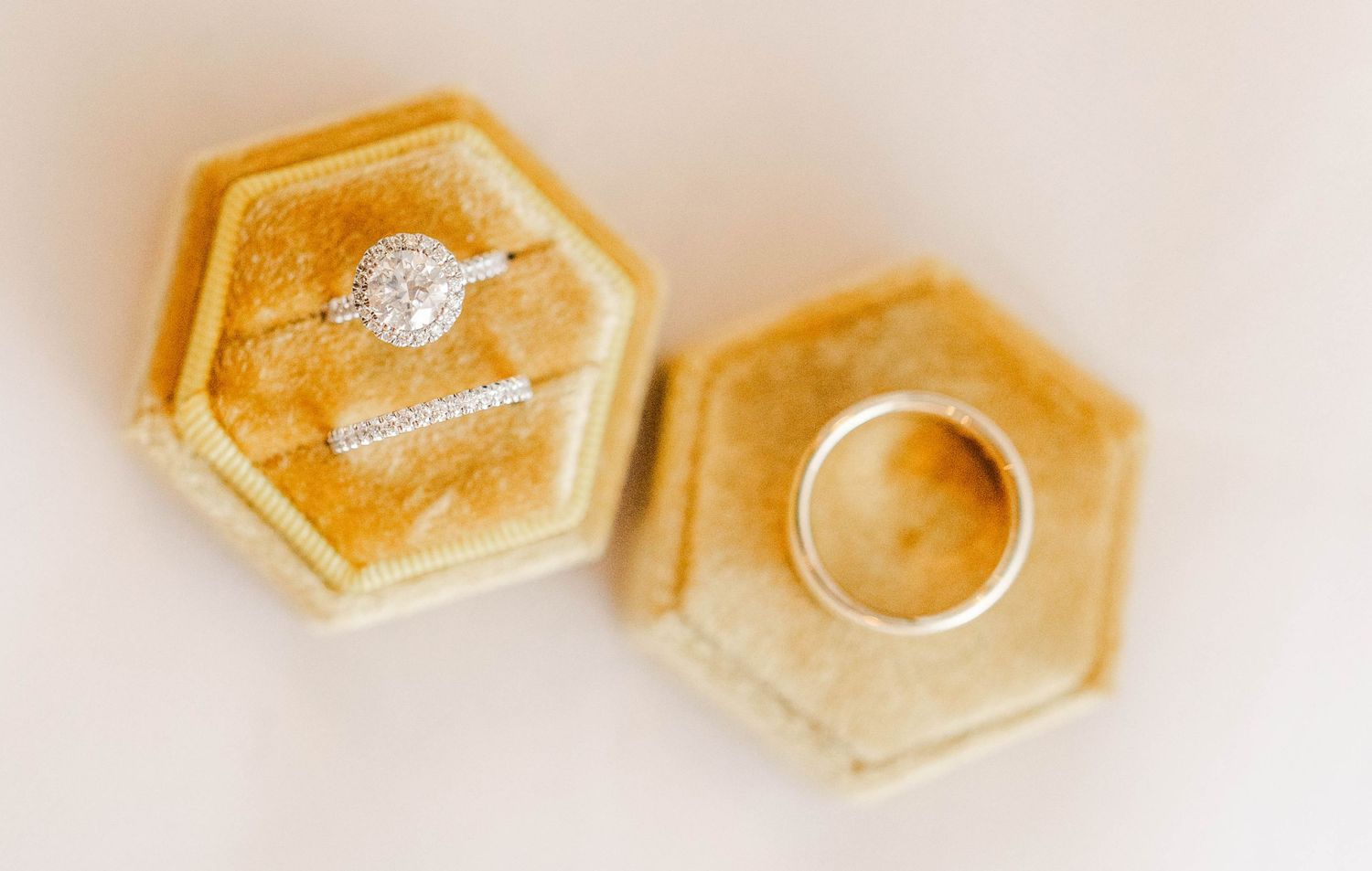 Delicate hexagonal ring dishes in translucent gold resin showcase a modern minimalist design on a light background.