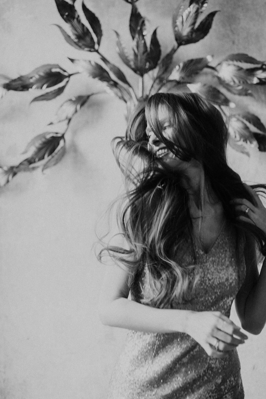 A black and white artistic photo sequence showing hair flowing and moving in a dynamic motion against a light background.