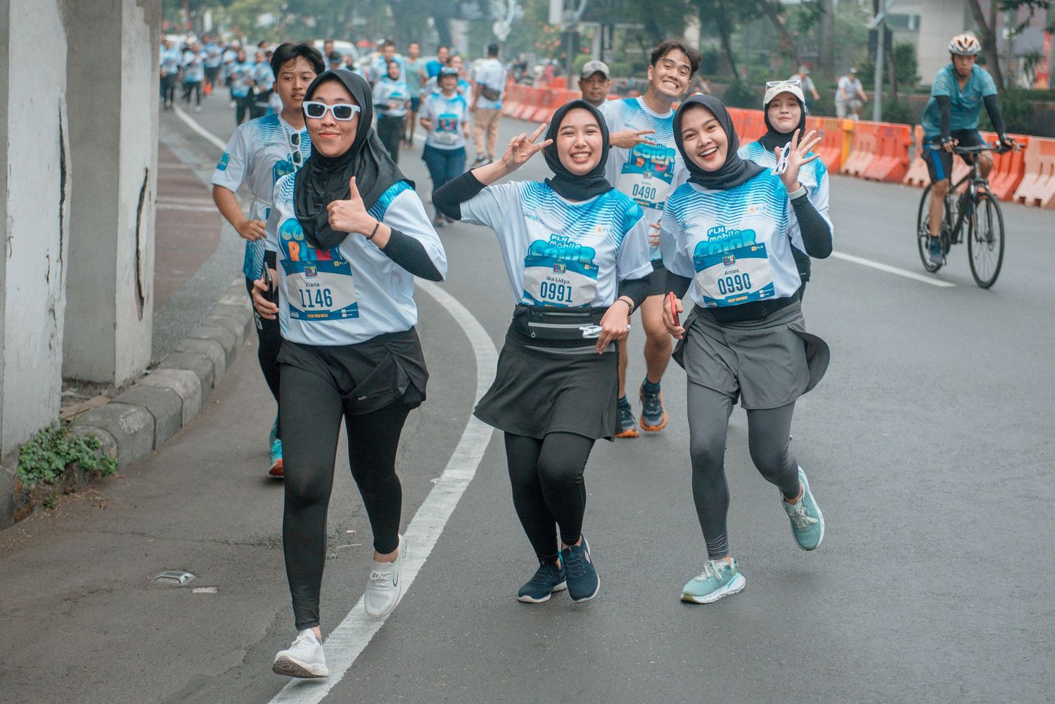 Sequence of runners stretching and warming up together before an outdoor race event.