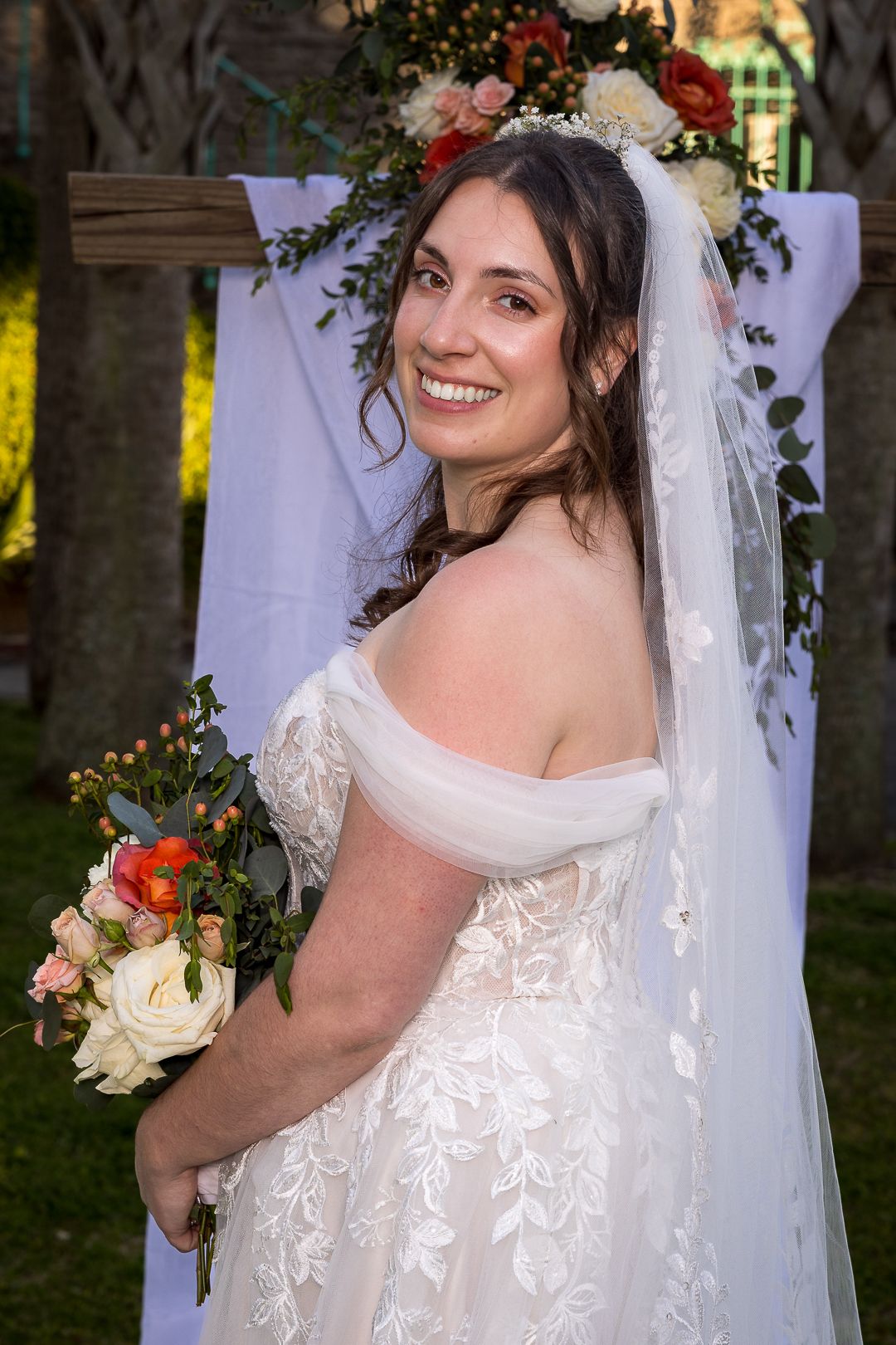 Frederick Maryland Wedding Photographer  -  Elegant lace wedding dress with delicate veil details and floral backdrop.