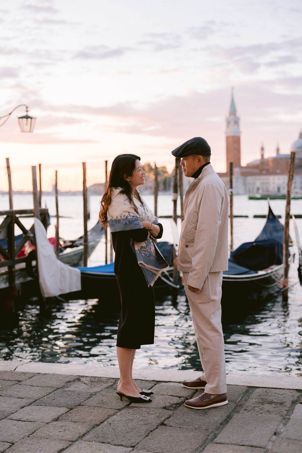 A romantic sequence of photos showing a couple by the gondolas in Venice at sunset with the iconic cityscape behind them.