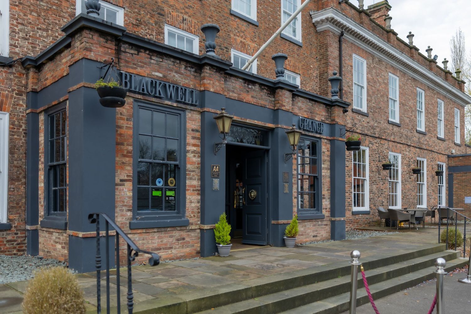 Historic brick buildings with steps along a commercial street in a traditional architectural setting. Blackwell Grange Wedding Darlington