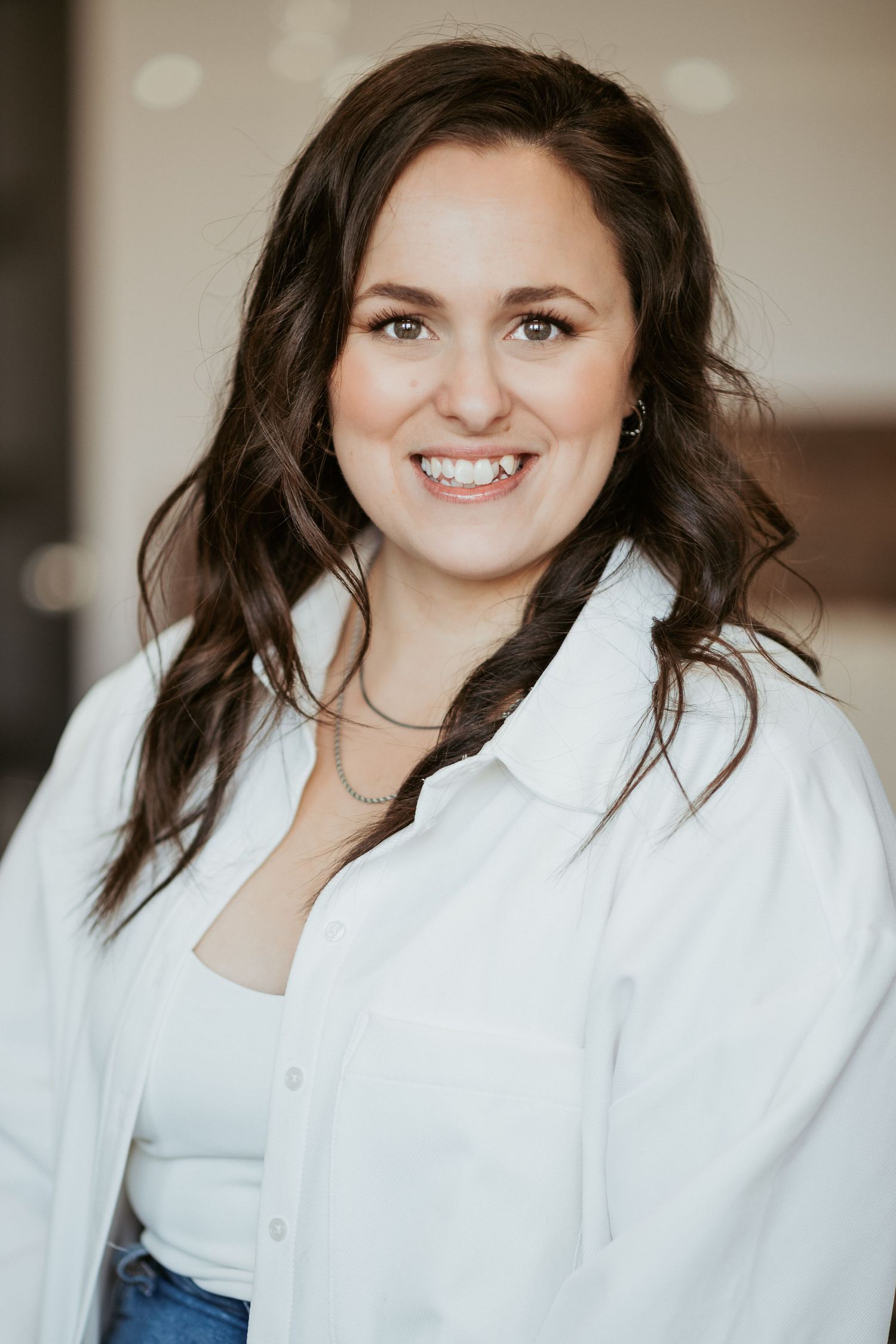 Studio portrait showing person in white button down shirt.