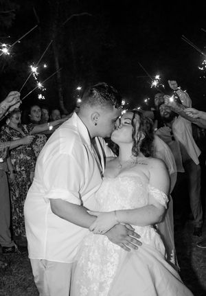 A romantic black and white photo sequence of newlyweds sharing their first dance at an outdoor evening reception.