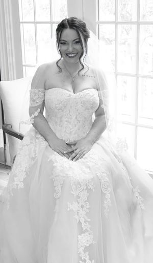Close-up shots of a bride in a stunning white lace wedding gown with intricate detailing and sweetheart neckline.
