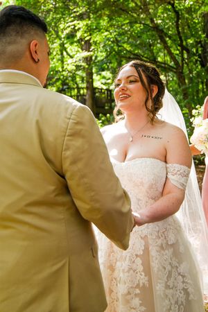 A romantic wedding sequence shows a couple in white lace and tan suit embracing in a sunlit forest setting.