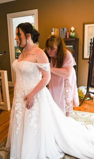 Behind-the-scenes shots of wedding dress preparations in an indoor setting with mirrors.