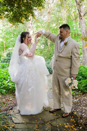 A series of romantic wedding photos showing a couple in formal attire dancing and embracing in a wooded outdoor setting.