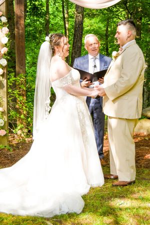 A wedding sequence showing a couple in white dress and tan suit sharing intimate moments under trees decorated with lights.