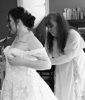 A series of intimate getting-ready moments showing the details of a white lace wedding dress being fastened.
