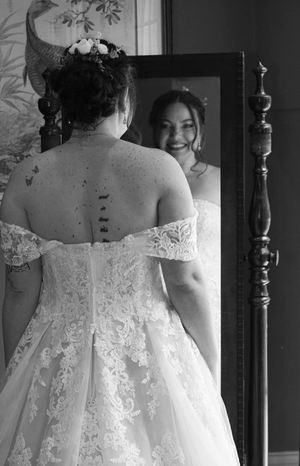 Black and white photos showing intricate lace details of a wedding dress from behind.