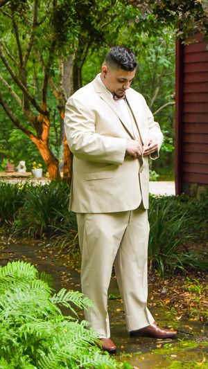 Sequence showing groom in beige suit adjusting his tie while standing in garden setting.