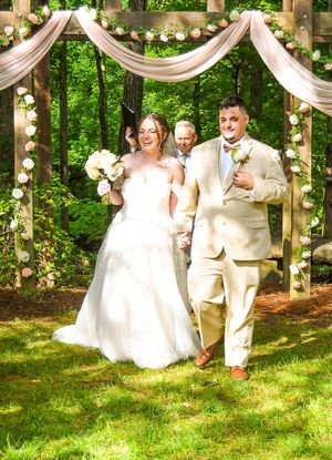 Joyful wedding celebration sequence showing couple dancing and spinning under draped fabric in a garden setting.