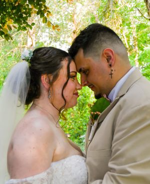 Romantic wedding couple shares intimate moments in a lush garden setting.