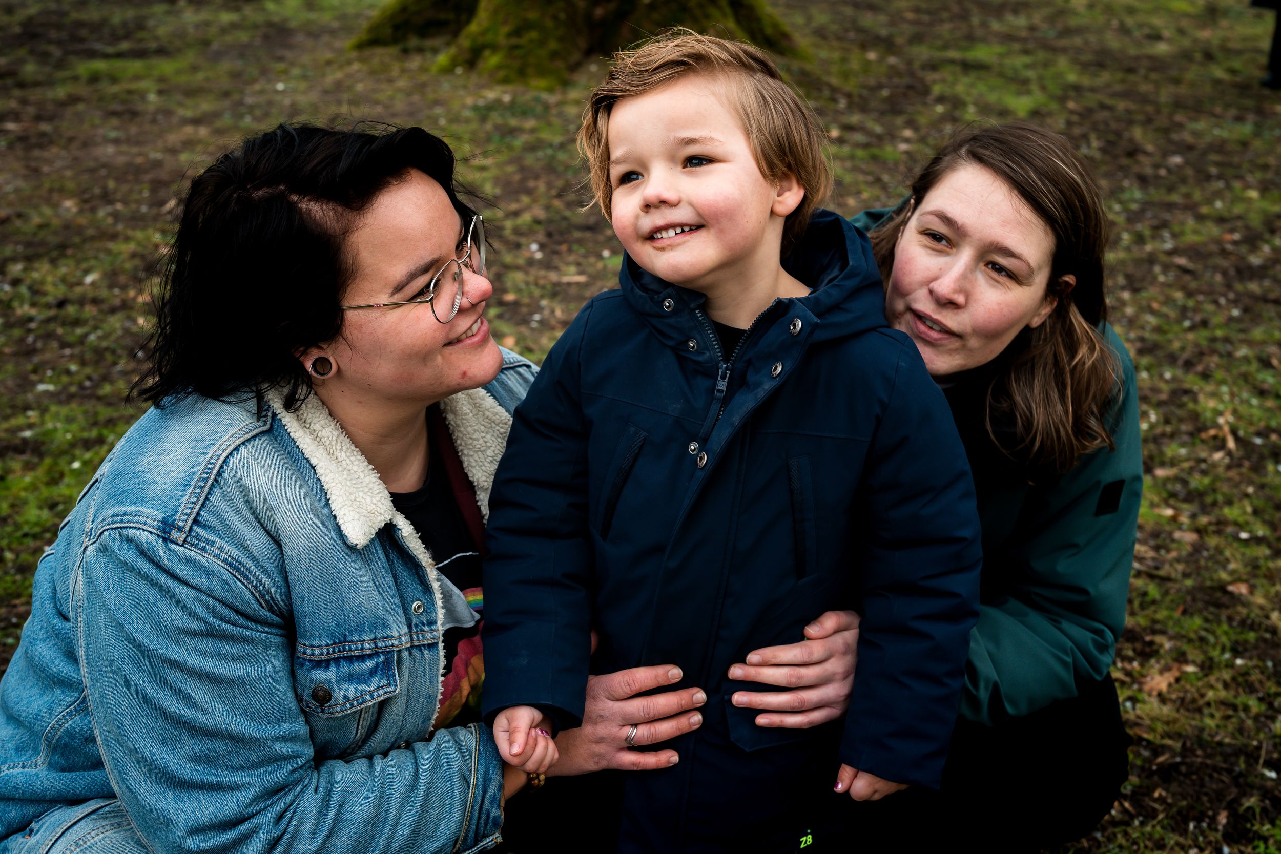 A series of candid outdoor family photos showing joyful moments and embraces in a natural setting.