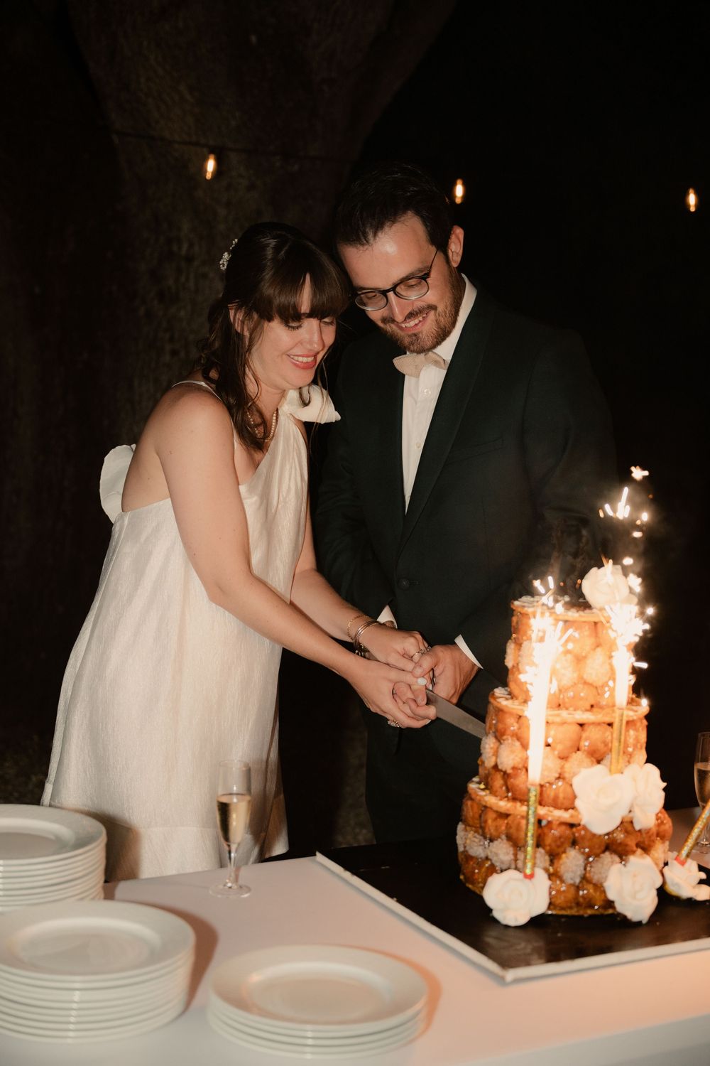 Mariage au Chateau Saint Esprit - Les mariés découpent leur pièce montée avec les bougies scintillantes.