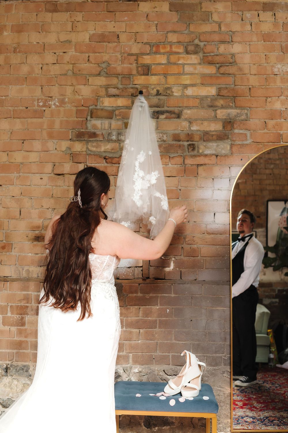 A sequence of wedding photos showing a couple dancing in front of a rustic brick wall backdrop.