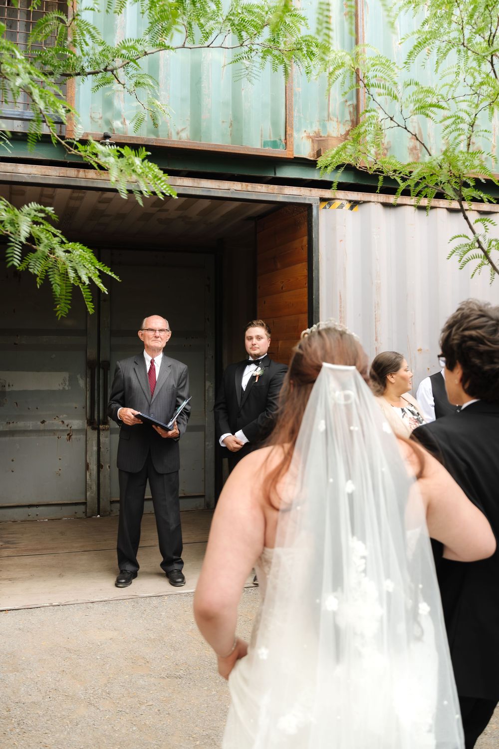A series of wedding photos showing preparations and moments before the ceremony in an outdoor courtyard setting.