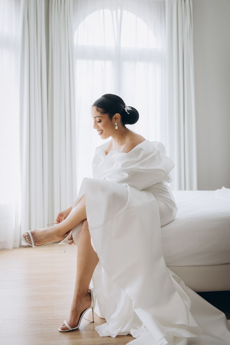 Bride getting ready with wedding dress in Barcelona morning light