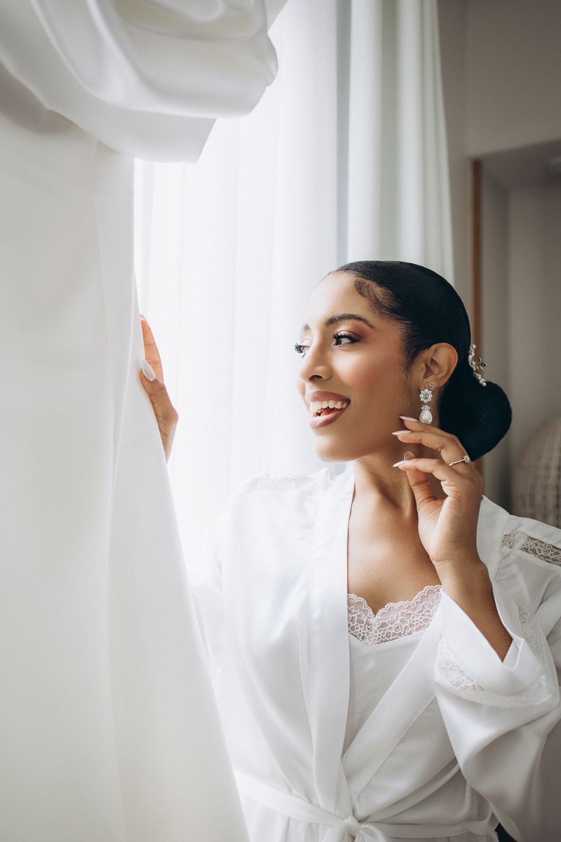 Bride getting ready with wedding dress in Barcelona morning light