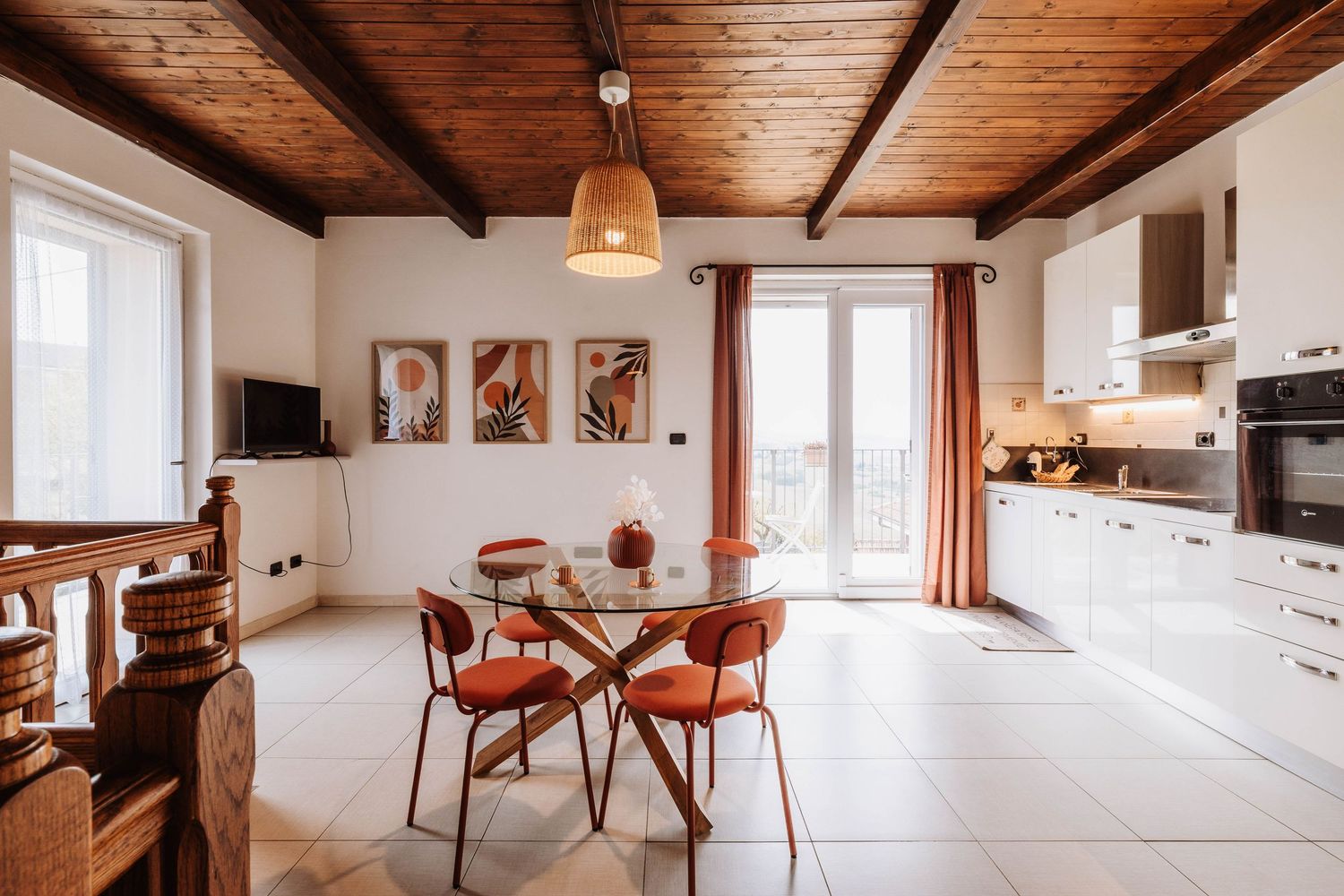 Modern apartment interior with exposed wooden beams and minimalist furnishings showcases clean lines and natural lighting.