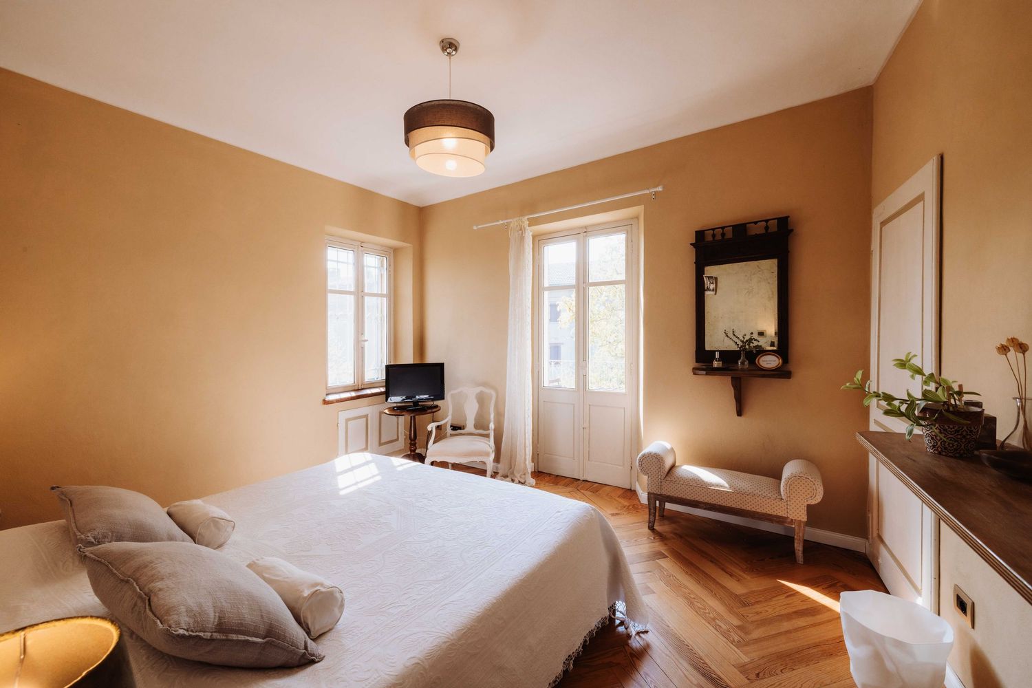 A collage of interior home photos showing beige walls, hardwood floors, and modern lighting fixtures.