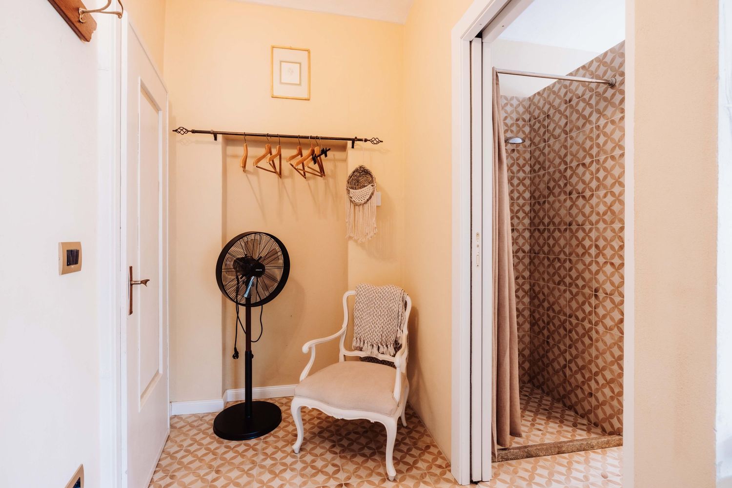 White hallway with doors and vintage style decor featuring a decorative radiator and wall sconces.