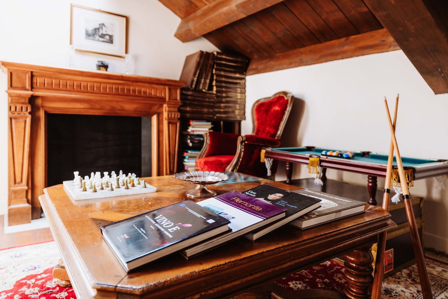 Cozy wooden chalet interior with exposed beams, rustic decor, and comfortable seating areas in a mountain lodge setting.