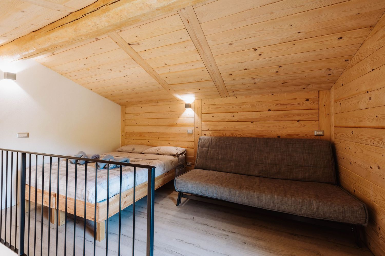 Wooden ceiling with exposed beams and recessed lighting in a rustic modern interior space.