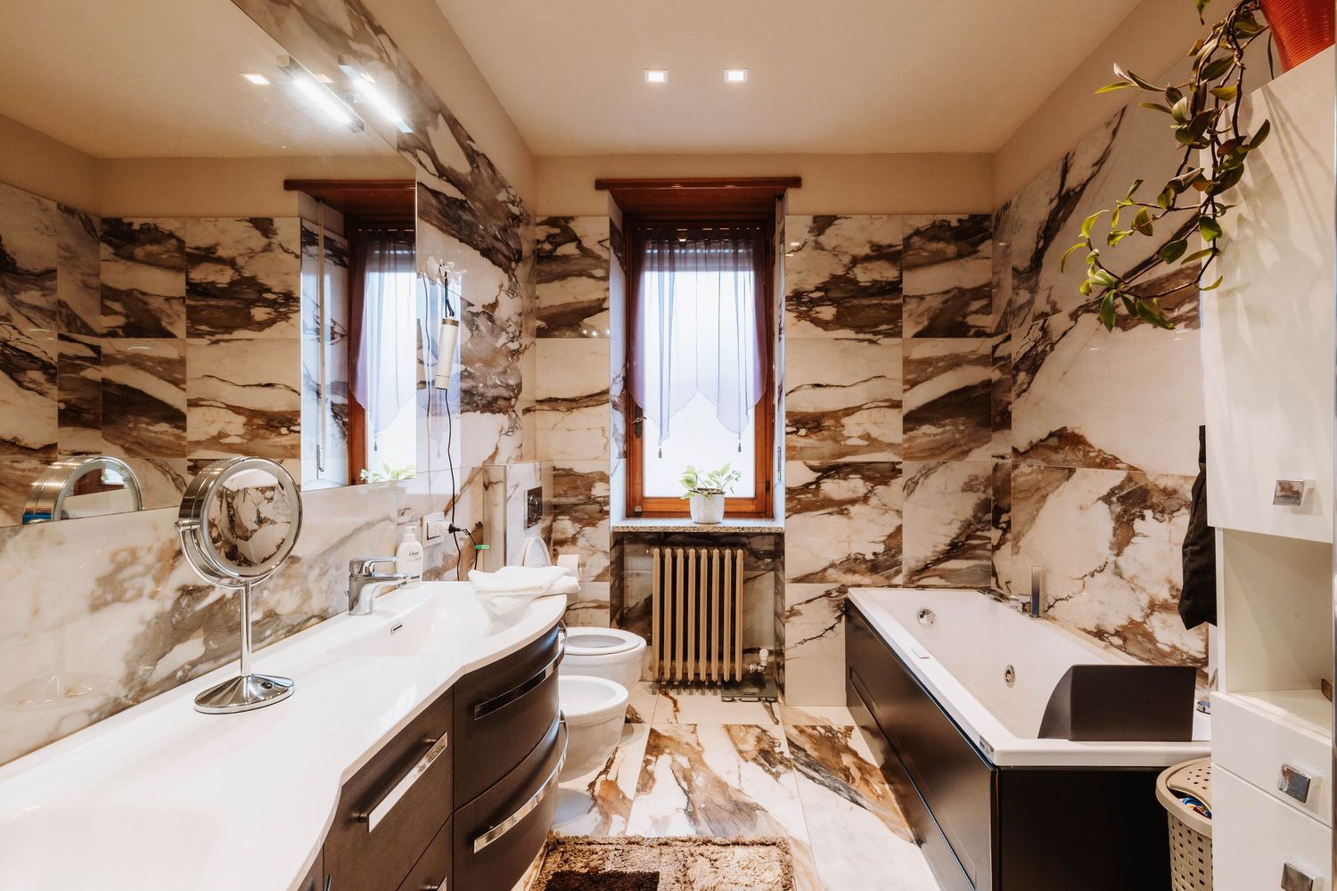 Damaged interior room with peeling wallpaper and exposed walls shows severe water damage and deterioration.