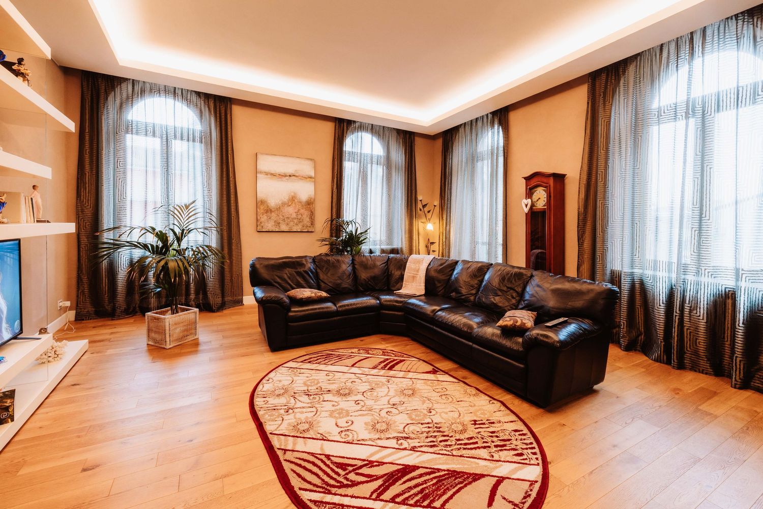 Panoramic view of a modern luxury bedroom interior with warm lighting and elegant furnishings.
