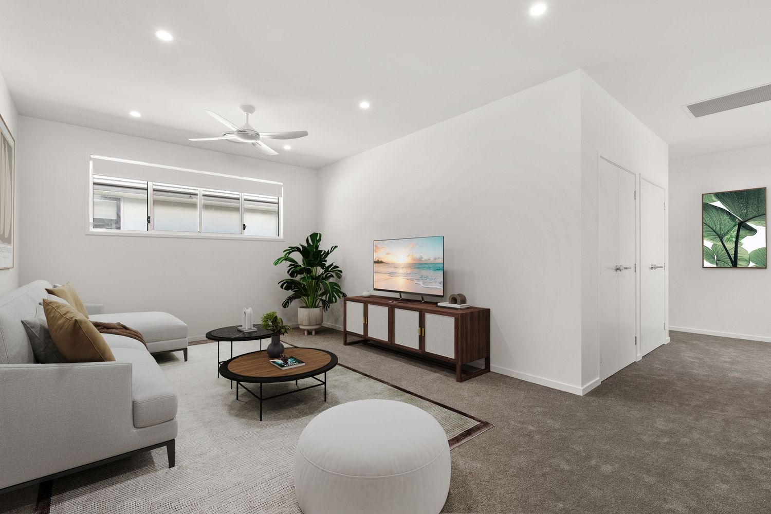 Modern carpeted living room with ceiling fan, wall-mounted TV, timber media unit, and abundant natural light from windows.
