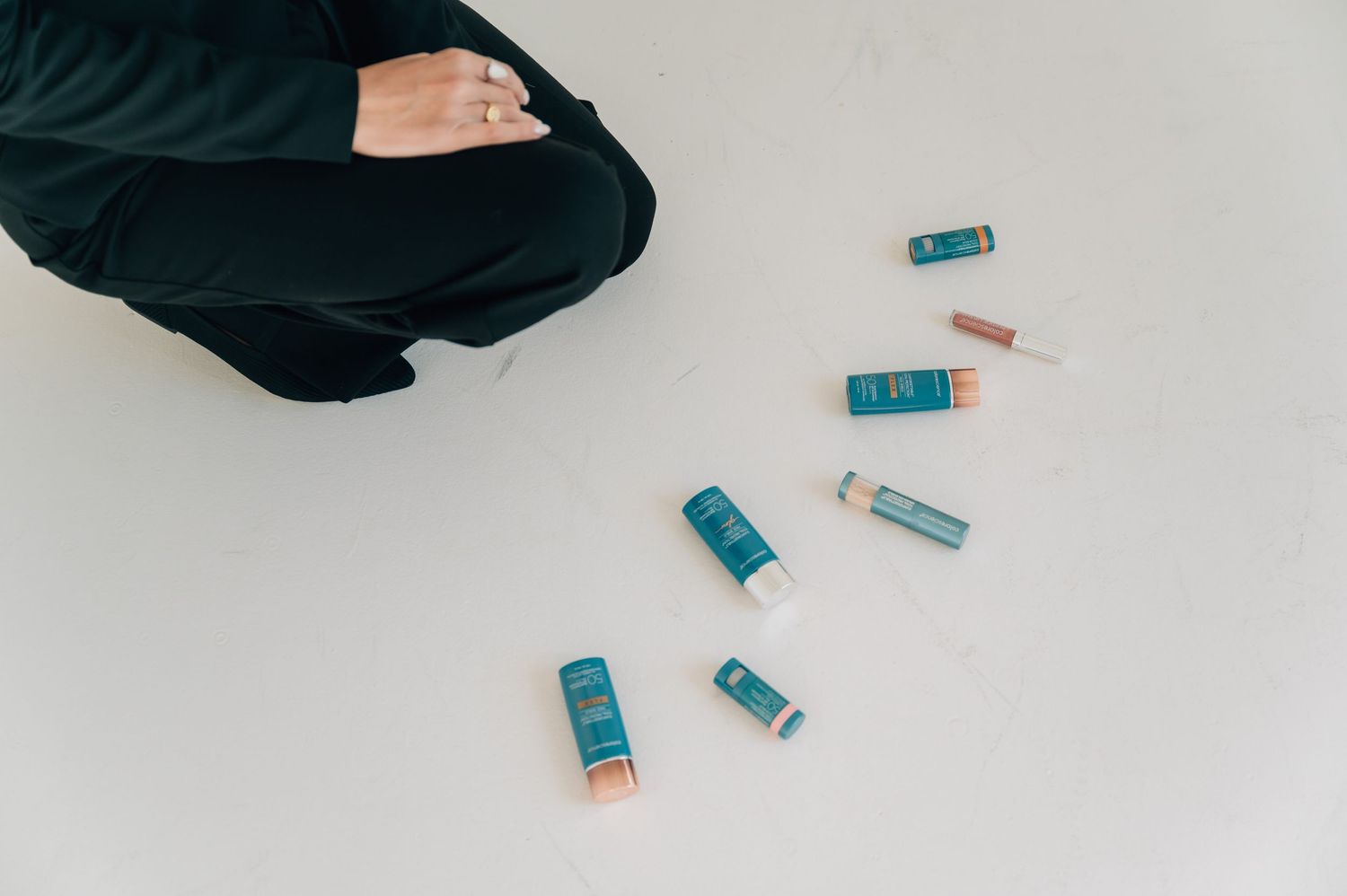 Several blue and orange vape cartridges scattered on a white surface next to a black fabric.