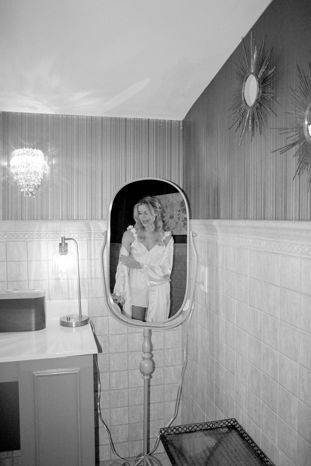 Black and white bathroom mirror selfies showing someone in casual attire.