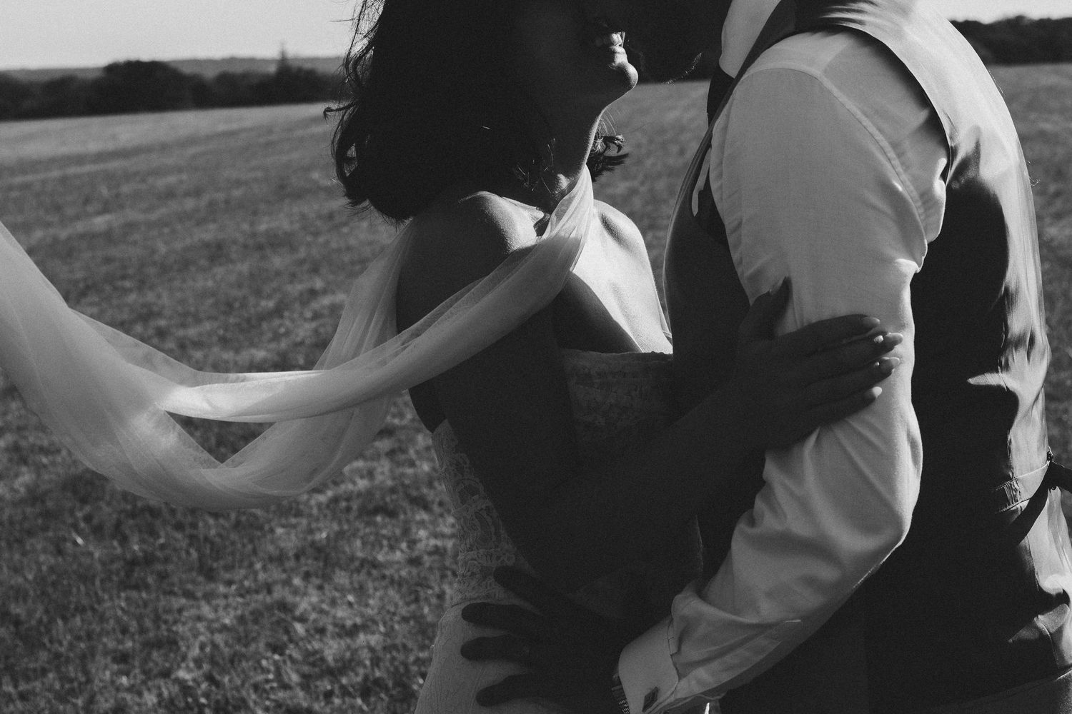 Tender black and white photo of the couple hugging and sharing a quiet moment.