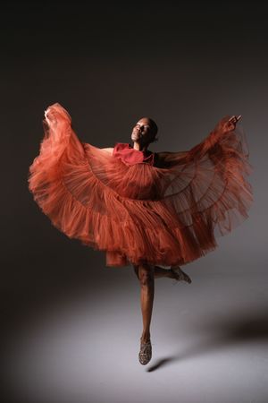 Dramatic dance poses captured in sequence showing flowing red dress movement.
