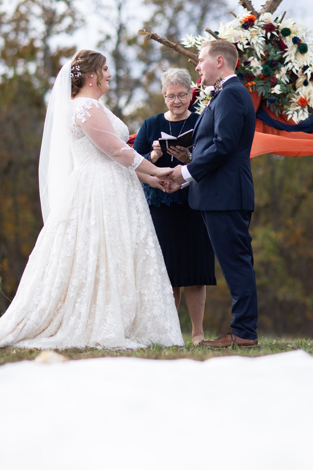 Bride and groom at altar during wedding ceremony by Joplin wedding photographer