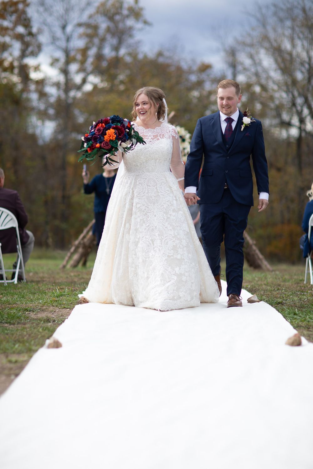 Bride and groom walking down the aisle by Joplin family photographer