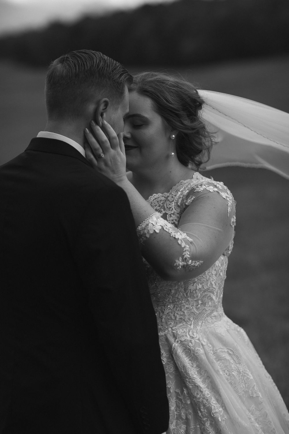 Black and white bride and groom photo in field after wedding by Joplin photographer