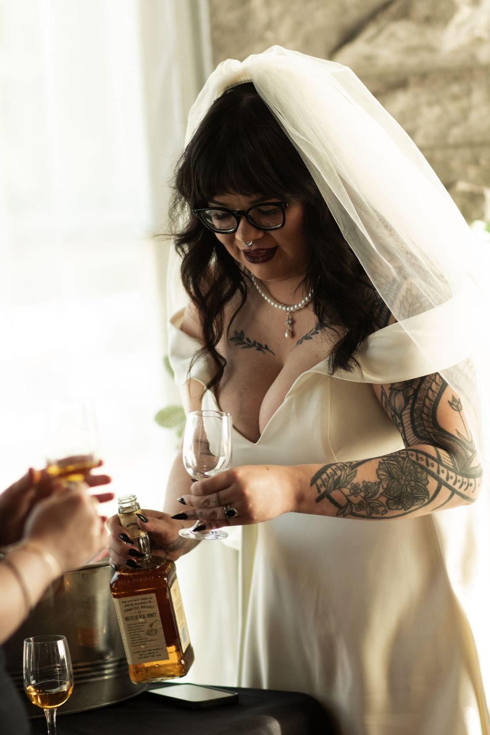 Bride serving drinks during Carthage wedding by Missouri wedding photographer