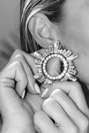 Black and white jewelry close-up featuring luxury crystal statement earrings in Jupiter Florida editorial session.