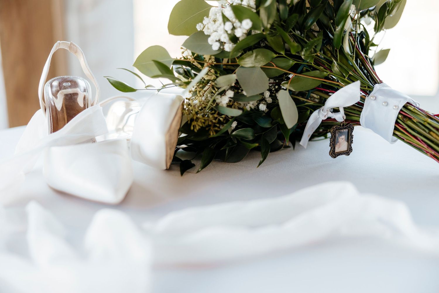 Elegant white floral and greenery wedding table decorations with soft natural lighting.