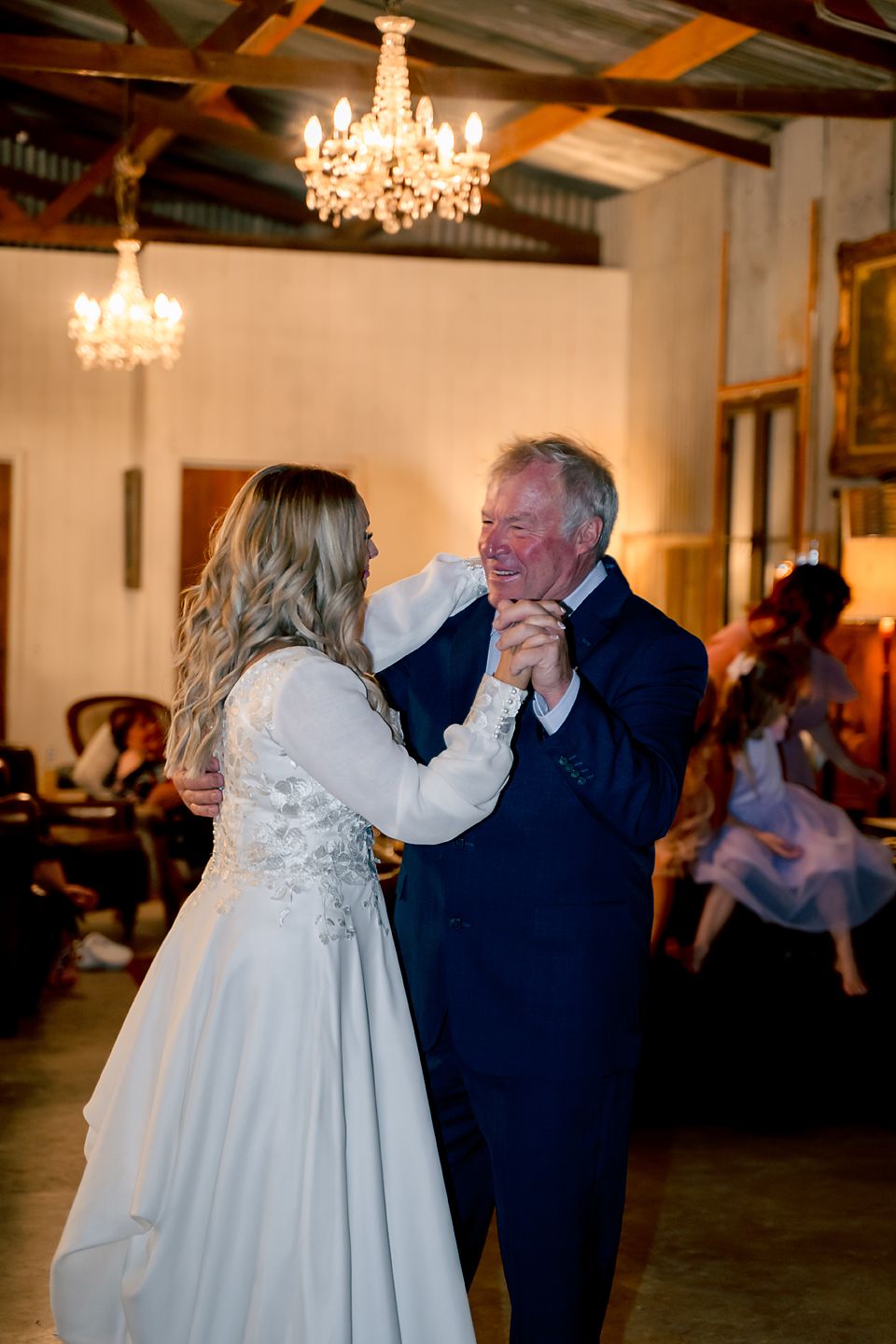 A series of photos showing a dance between a bride in a white dress and an older gentleman under crystal chandeliers.