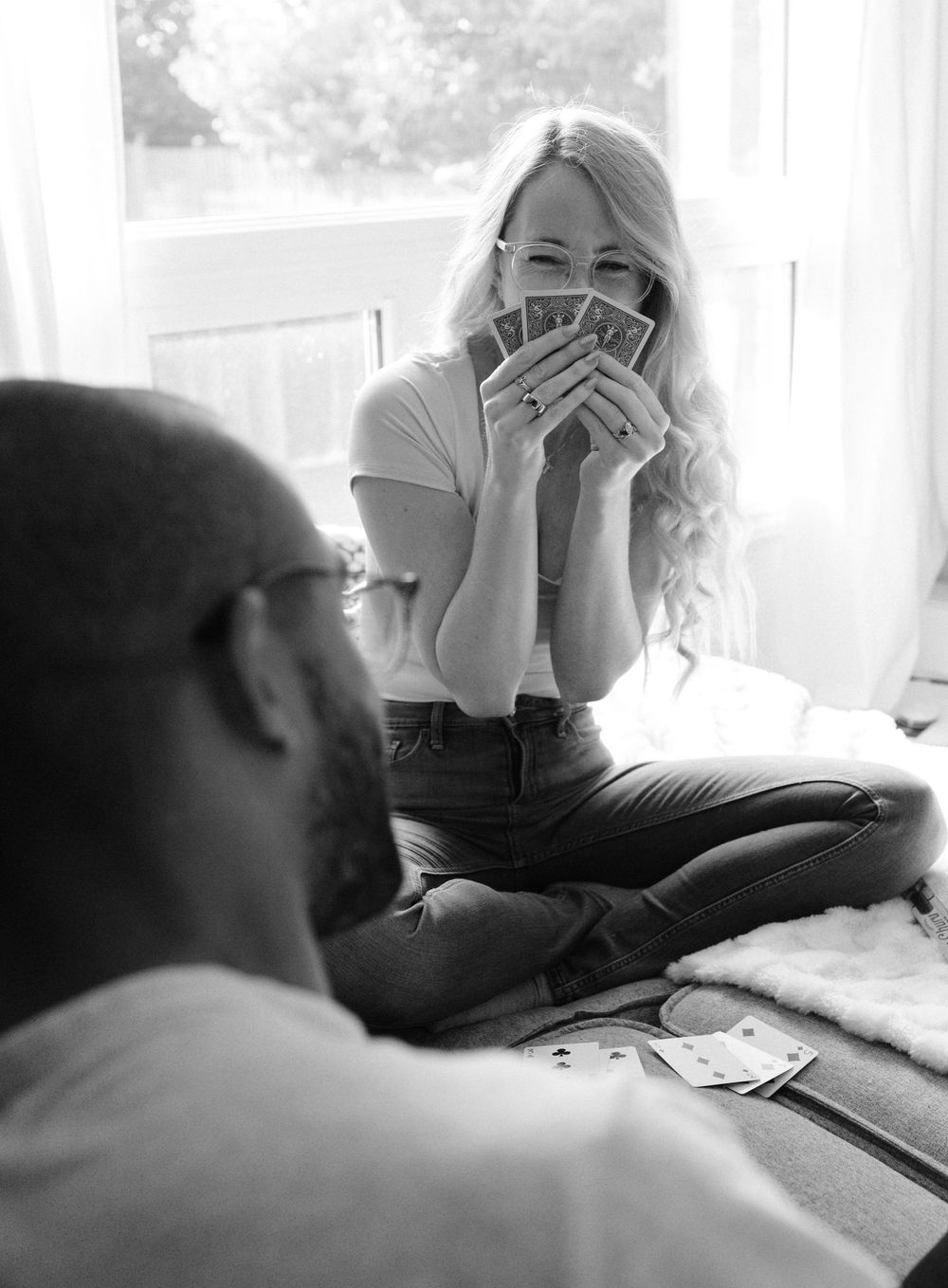A series of black and white photographs showing a person lying down while another sits nearby expressing concern.