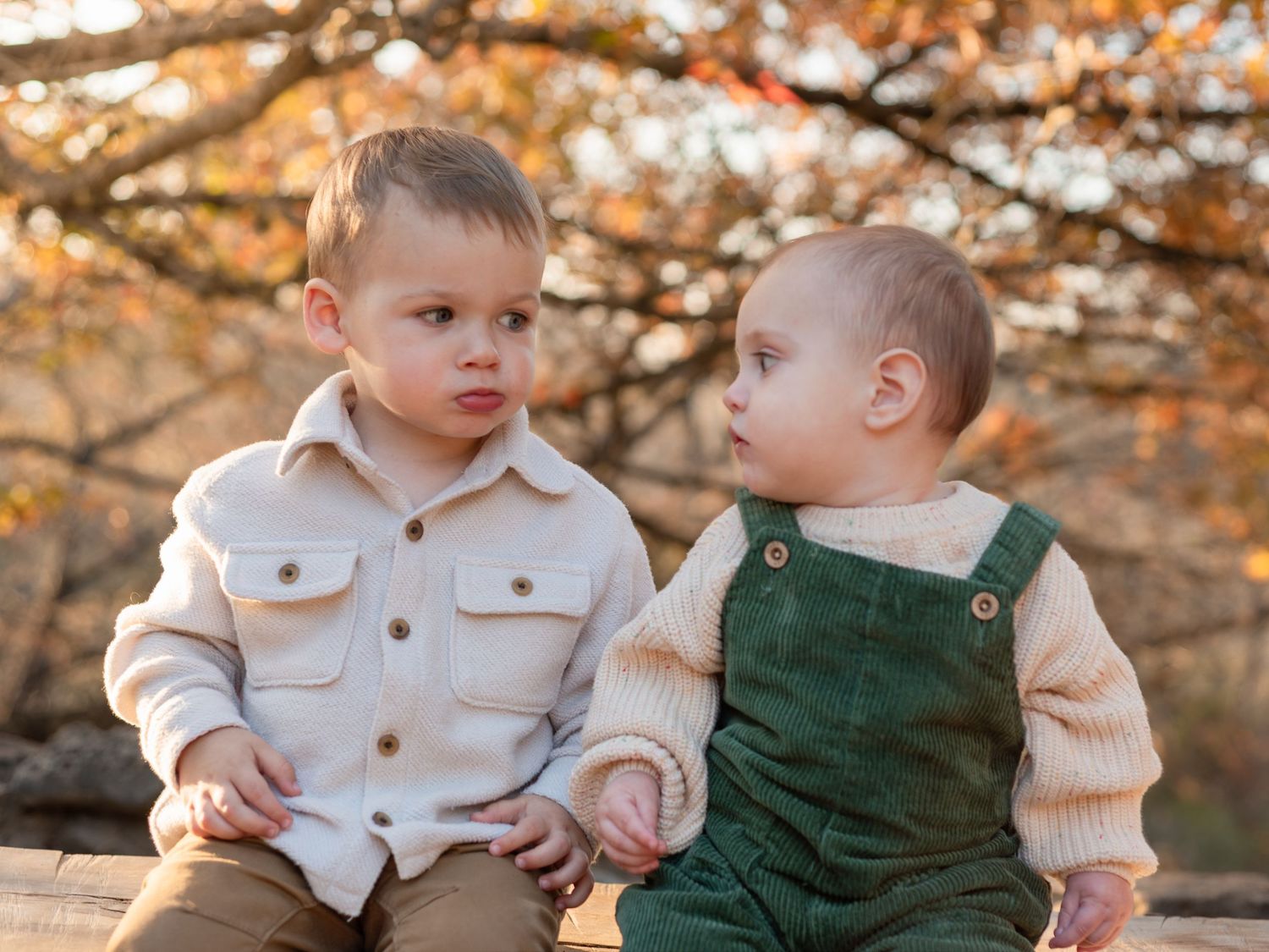 Young cousins sitting together during extended family session at McKinney Falls State Park in Texas