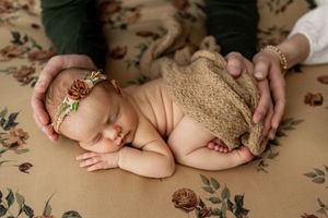 A collage of newborn baby photography showing close-up details of tiny hands, feet and sleeping poses on beige fabric.