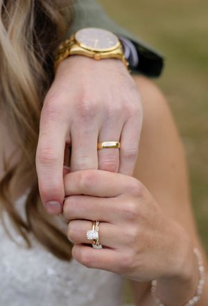 Close-up sequence of engagement and wedding rings on bride's hand.
