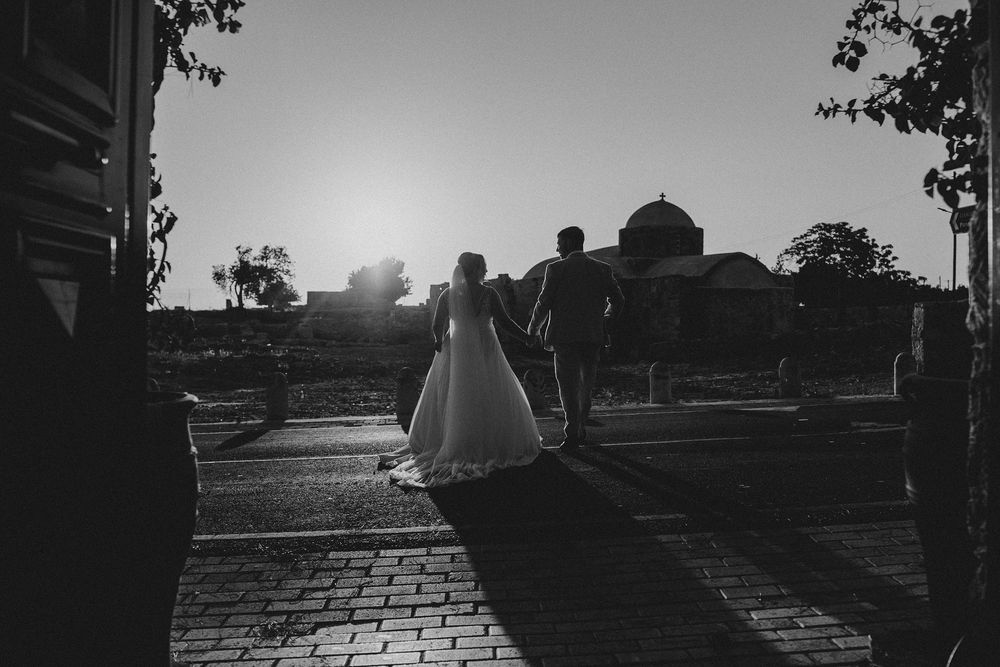 A series of black and white photos showing silhouettes of buildings and trees against a bright sky at sunset.