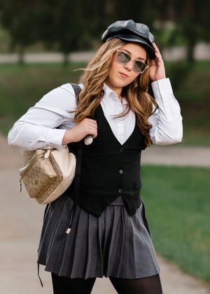 Fashion photo series showing playful poses in black pleated skirts and white tops.